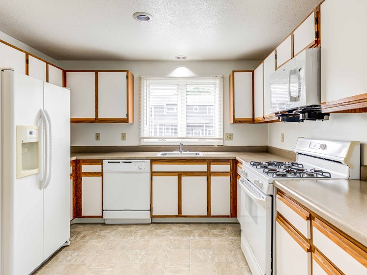 large kitchen with white appliances